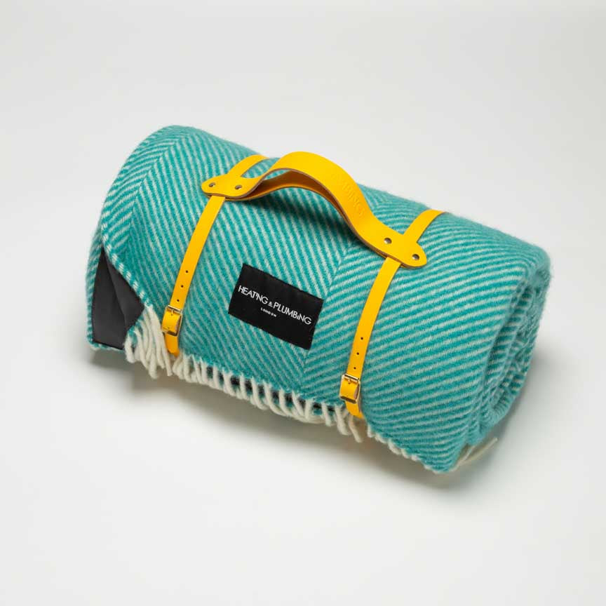 Picnic blanket in turquoise blue with waterproof backing and yellow strap