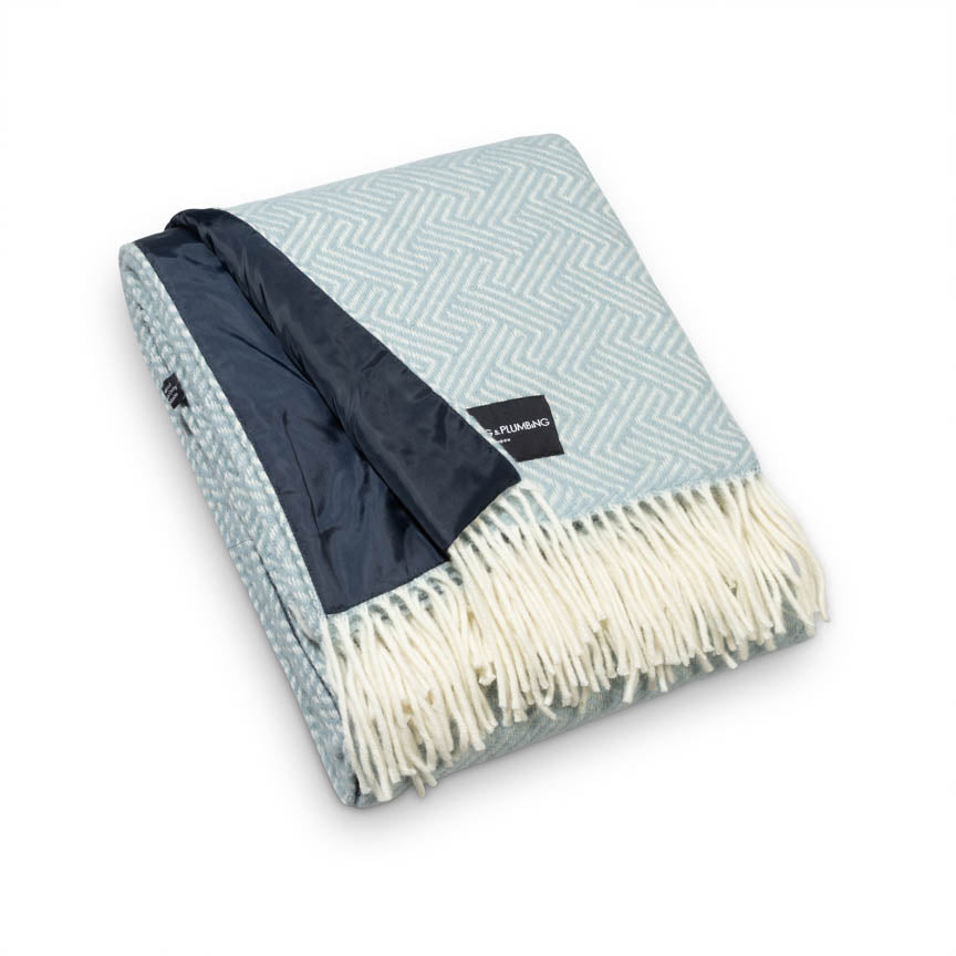 Duck egg blue wool picnic blanket with cream fringe and waterproof navy backing, folded neatly – Heating & Plumbing London