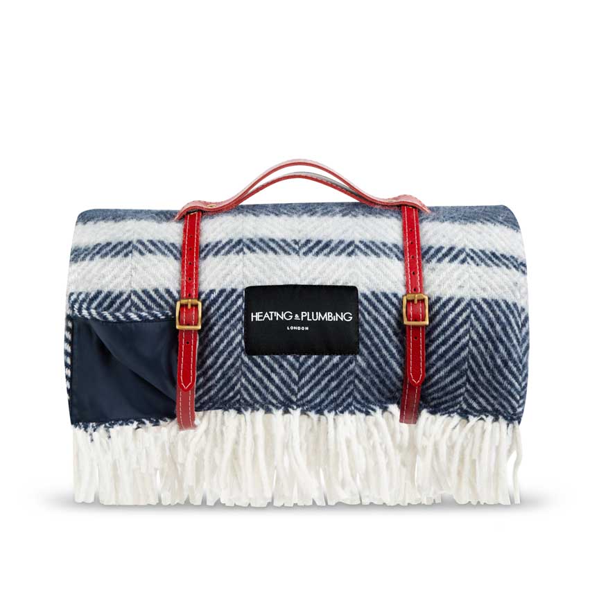 Blue with grey stripe outdoor blanket with a red leather strap