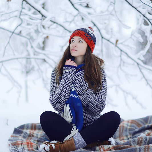 girl sitting on blanket in the snow