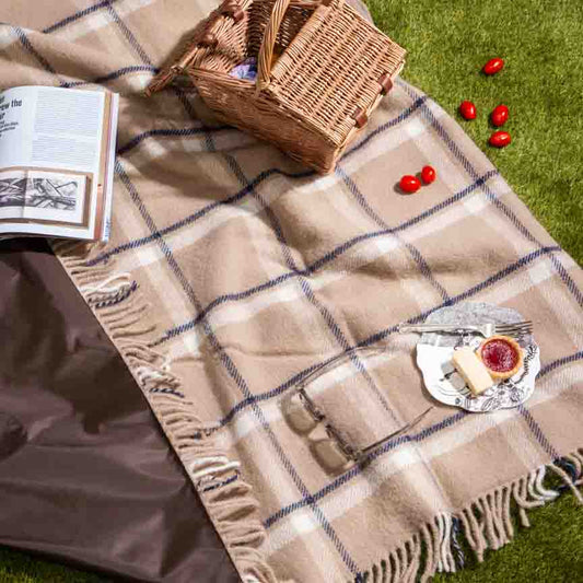 Lifestyle shot of beige checkmate latte wool picnic blanket