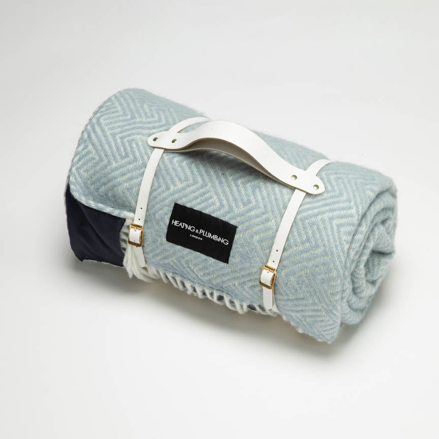 Duck egg blue wool picnic blanket with white leather strap. 