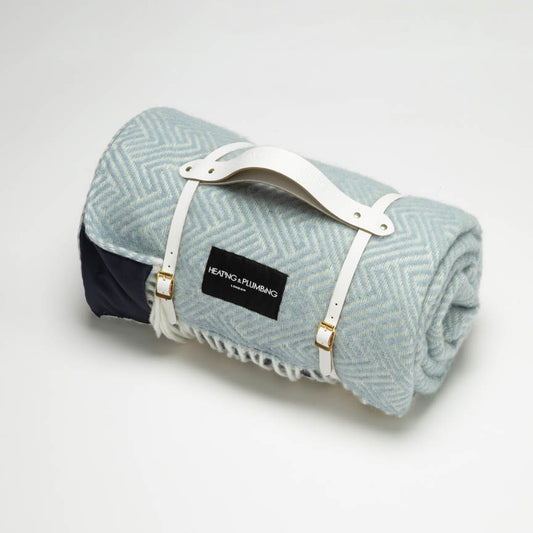 Duck egg blue wool picnic blanket with white leather strap. 