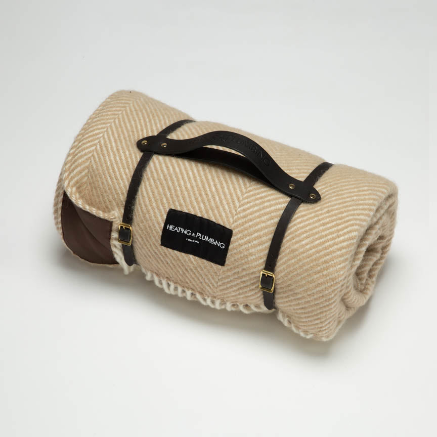 Beige light brown wool picnic blanket with black leather strap