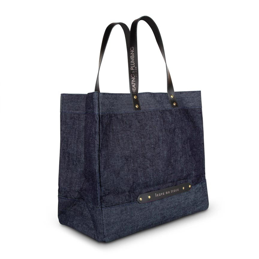 blue denim bag with black leather handles 